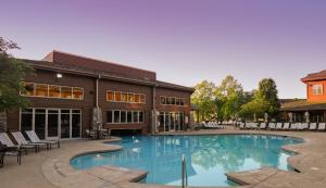 a large swimming pool in front of a large building at The Lodges at Timber Ridge by Vacation Club Rentals in Branson