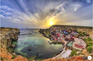 an aerial view of a town on a cliff at Sea View Apartment Mellieha in Mellieħa