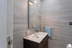 a bathroom with a sink and a mirror at Sea View Apartment Mellieha in Mellieħa +33 photos