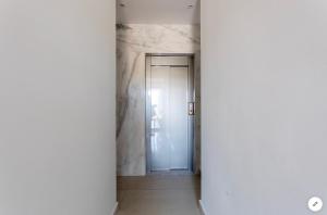 an empty corridor with a door in a building at Sea View Apartment Mellieha in Mellieħa