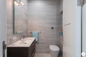 a bathroom with a sink and a toilet at Sea View Apartment Mellieha in Mellieħa