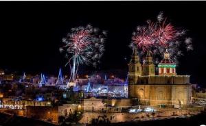 a night view of a city with fireworks at Sea View Apartment Mellieha in Mellieħa