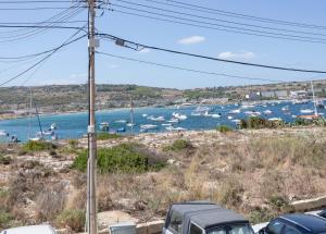 a view of a harbor with boats in the water at Sea View Apartment Mellieha in Mellieħa