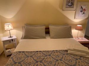 a bedroom with a large bed with pillows and a lamp at Affittacamere Le Terrazze in Corniglia