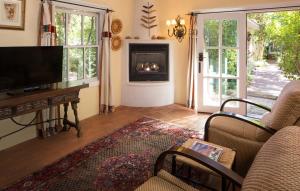 a living room with a tv and a fireplace at Casa Blanca Inn and Suites in Farmington