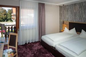Postel nebo postele na pokoji v ubytování Hotel Pockinger Hof