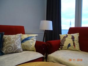 a living room with two chairs and a window at ORA-PRN,cosy apartment in the city center in Pristina