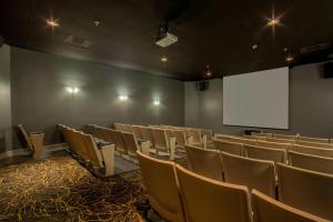 an empty lecture room with chairs and a white screen at Cape Canaveral Beach Resort in Cape Canaveral +27 photos