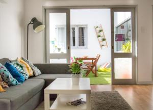 a living room with a couch and a table at Travel & Live Porto Hostel in Porto