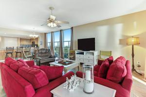 a living room with red furniture and a flat screen tv at Sterling Shores III in Destin