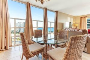 a dining room with a glass table and chairs at Sterling Shores III in Destin