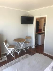 a dining room with a table and two chairs at ROTORUA EASTSIDE APARTMENTS in Rotorua