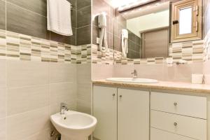 a bathroom with a sink and a toilet and a mirror at B&B Rome Termini House in Rome
