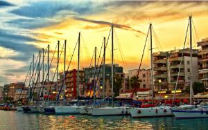 a group of boats docked in a marina at sunset at SUNNY CENTRAL LUXURY APARTMENT in Volos