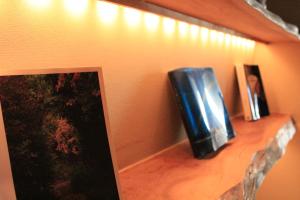 a shelf with a television on top of a wall at Kotsubokaigan Linca in Zushi