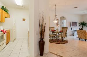 a kitchen and dining room with a table and chairs at DREAM Vacation BY A3G in Orlando