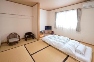 Postel nebo postele na pokoji v ubytování Shimayado Goen