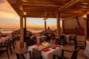 a restaurant with tables and chairs with a view of the ocean at Pueblo Bonito Mazatlan Beach Resort - All Inclusive in Mazatlán