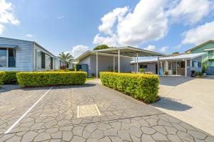 a row of houses and bushes in a driveway at Tin Can Bay's Sleepy Lagoon Motel in Tin Can Bay