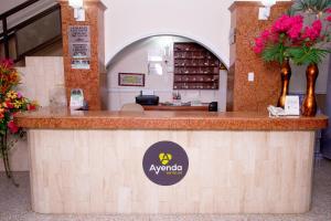 a restaurant with a counter with a sign on it at Ayenda 1309 Villa Dilia in Barranquilla
