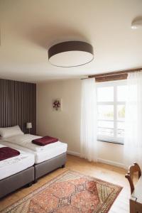 a bedroom with two beds and a large window at Altes Pfarrhaus in Geldern