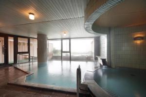 a swimming pool in the middle of a building at Hotel Taiko in Myoko
