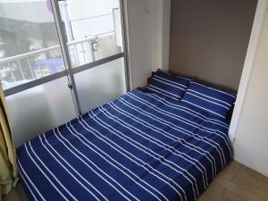 Кровать или кровати в номере Guest House ZEN HAKATA Ohori Park 1