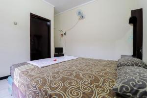 Postel nebo postele na pokoji v ubytování Cempaka Hotel