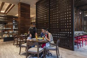 a group of people sitting at a table in a restaurant at Clark Marriott Hotel in Clark