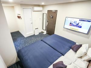 เตียงในห้องที่ HOTEL LiVEMAX BUDGET Fuji Ekimae