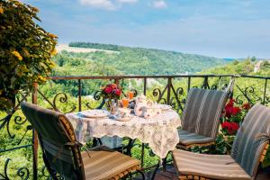 a table with chairs and a table cloth with flowers on it at Burghotel in Rothenburg ob der Tauber