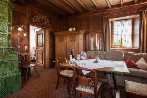 a living room filled with furniture and a large window at Burghotel in Rothenburg ob der Tauber