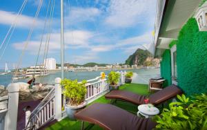 a balcony with chairs and a view of the water at Signature Halong Cruise in Ha Long