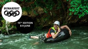 a man riding on a raft in a river at Hotel Antika in Prizren