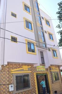 a man standing in the doorway of a building at Hotel Laxmi Sadan in Somnath