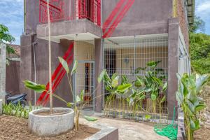 a plant in a pot in front of a building at KoolKost near ISI Yogyakarta (with minimum stay applies) in Yogyakarta
