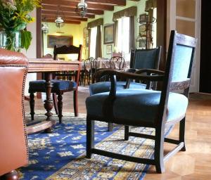 a living room with a table and chairs and a chair at Zagrodowa Osada in Kazimierz Dolny
