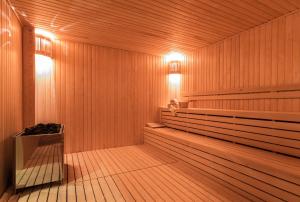 a wooden sauna with benches and lights in it at Boyalik Beach Hotel & Spa Cesme in Çeşme