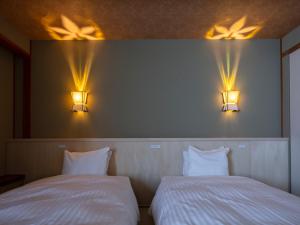 Postel nebo postele na pokoji v ubytování Gion Ryokan Karaku