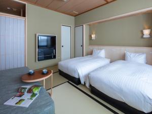 Postel nebo postele na pokoji v ubytování Gion Ryokan Karaku