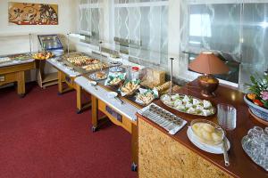 a buffet line with many different types of food at Pensiunea Ambient in Braşov