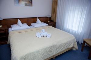 Postel nebo postele na pokoji v ubytování Hotel Baden