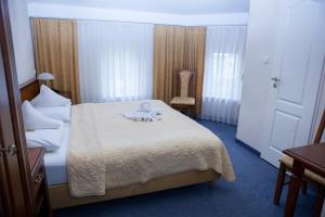 Postel nebo postele na pokoji v ubytování Hotel Baden