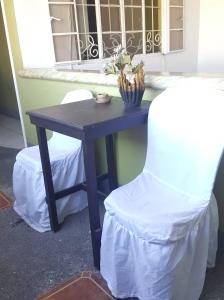 a table and a chair in front of a window at Center Parkway Pension House in Kalibo