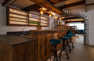 a bar with blue stools in a restaurant at Bergnest die Frühstückspension in Katschberghöhe
