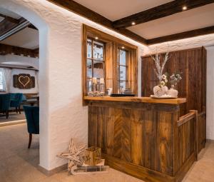 a reclaimed wood bar in a dining room with a window at Bergnest die Frühstückspension in Katschberghöhe