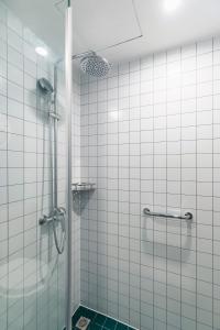 a bathroom with a shower with a glass door at Campanile Shanghai Huaihai in Shanghai