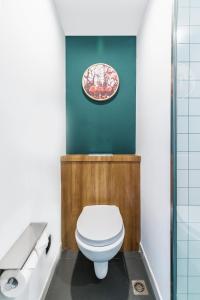 a bathroom with a toilet and a plate on the wall at Campanile Shanghai Huaihai in Shanghai