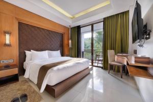 Postel nebo postele na pokoji v ubytování Golden Tulip Jineng Resort Bali