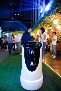 a white and black blender sitting on a green carpet at Campanile Shanghai Huaihai in Shanghai